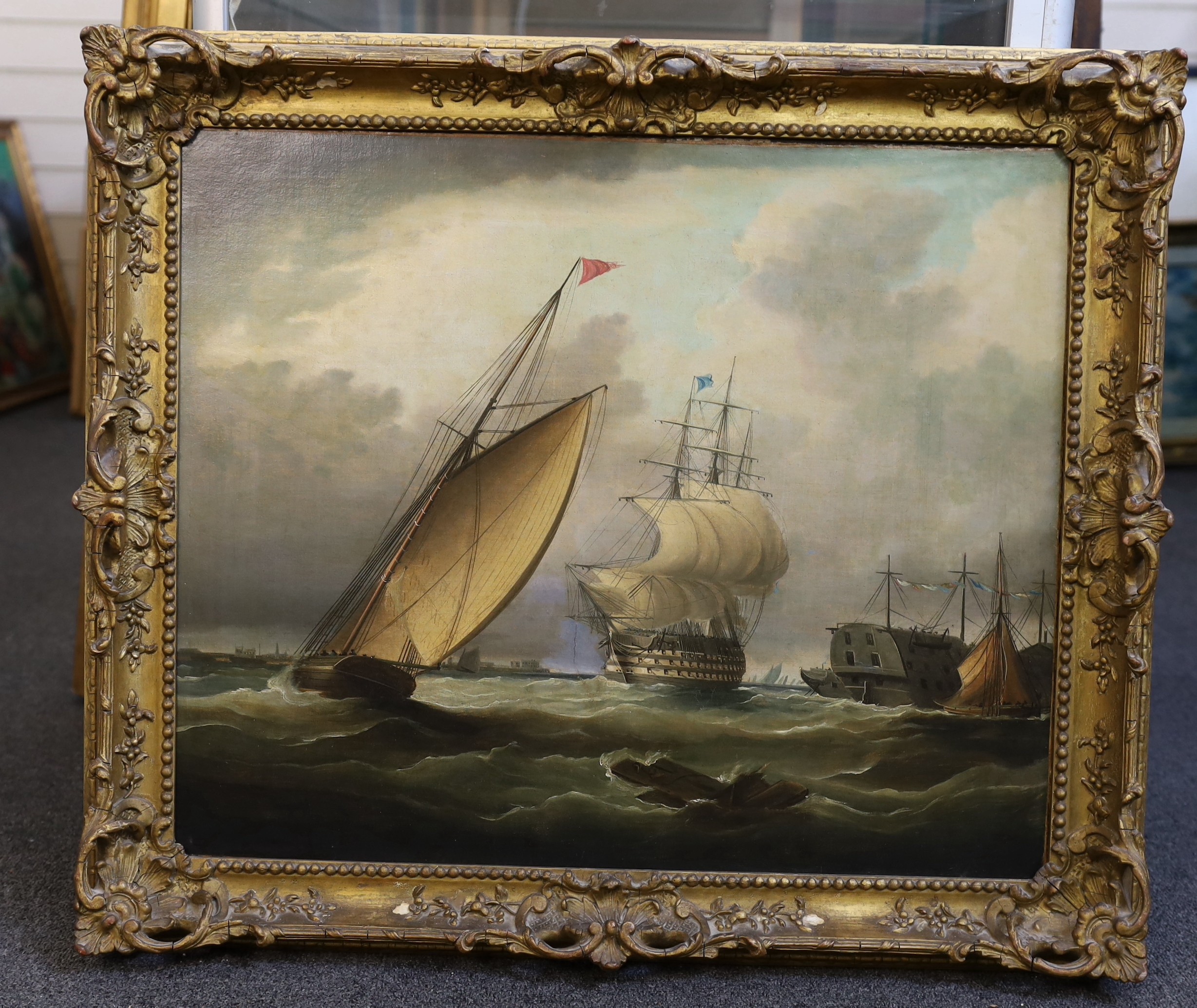 Follower of Charles Brooking (British, c.1723-1759), Shipping off the coast with a frigate flying a blue flag, hulks and other sailing ships, oil on canvas, 50 x 60cm